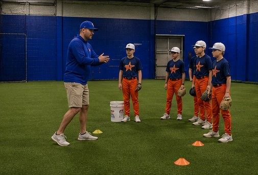 NVBA coach instructing a group of young NV Stars players on the indoor turf field